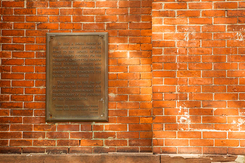 A plaque outside the Dutch Reformed Church in Port Richmond, Staten Island on Friday Oct. 25, 2013. To the right is the outline of a plague stolen by vandals. (Gordon Donovan)