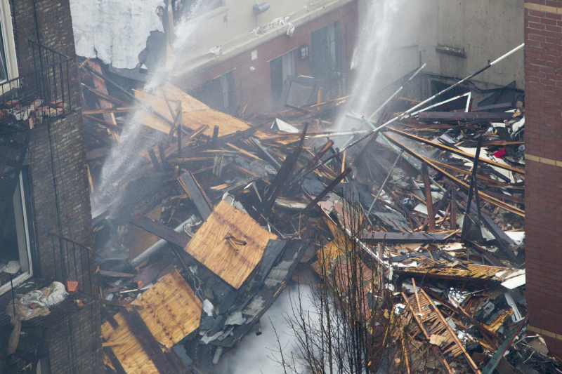 A firefighting ladder sits on of the rubble from an explosion where two buildings collapse in the Harlem section of New York City, March 12, 2014. (Gordon Donovan/Yahoo News)