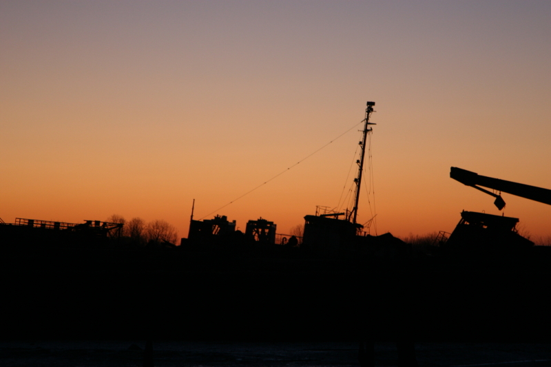 The silhouette of retired ships as the sun sets in the Rossville section of Staten Island. (Gordon Donovan)