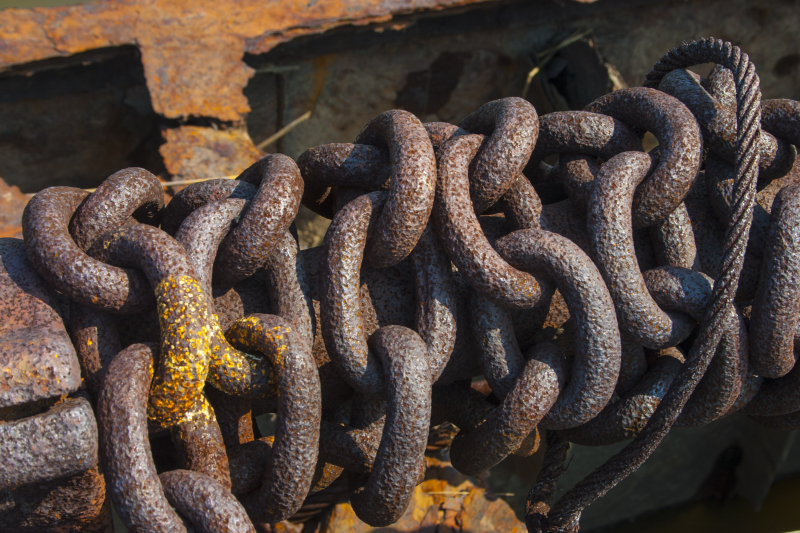 Chains of an old anchor on the rusting deck of a ship. (Gordon Donovan)