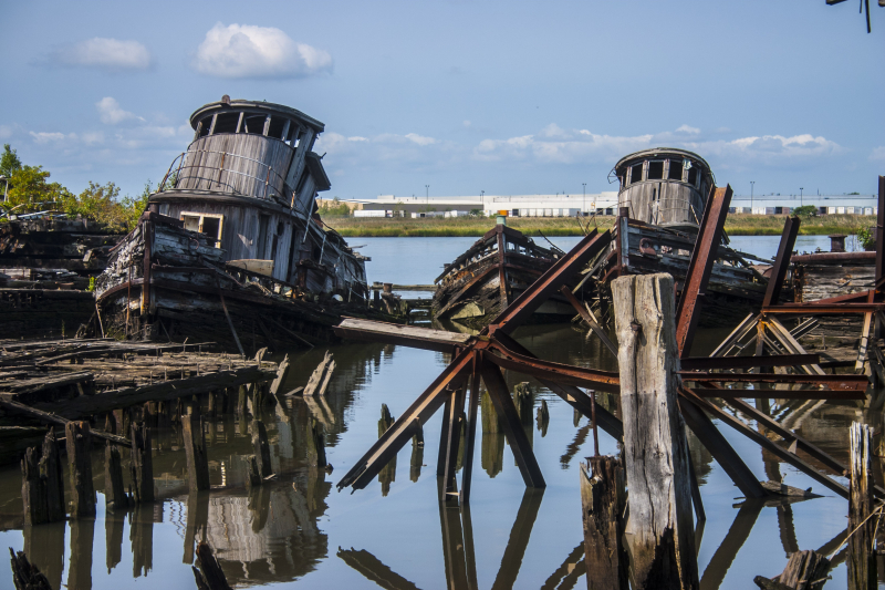 Making your way out to photograph these old two old wooden tug boats is very dangerous. The wooden piers are been the victim of fire and age. The spikes used to built the piers are visible. (Gordon Donovan)