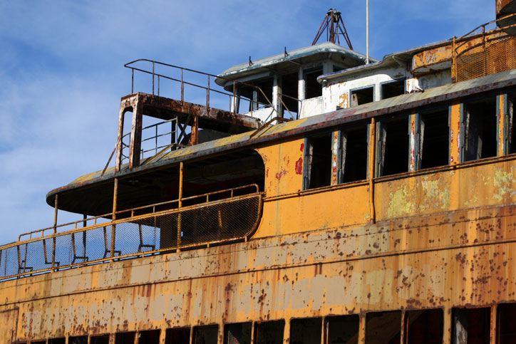 A retired Staten Island Ferry waiting to be scrapped sits docked next to a scrap metal yard. (Gordon Donovan)