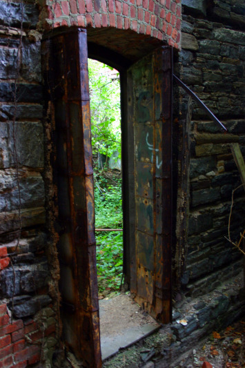 Rusting steel doors leading to a courtyard. (Gordon Donovan)