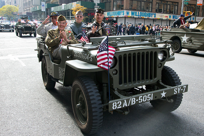 Veterans salute while riding a jeep during the Veterans Day parade on Fifth Avenue in New York on Nov. 11, 2014. (Gordon Donovan)