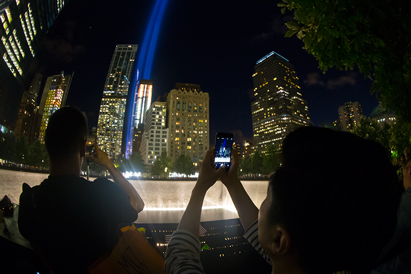 A visitor takes a photo with his smart phone of "The Tribute in Light" at the National September 11 Memorial & Museum on Friday, Sept. 11, 2015. It was the 14th anniversary of the Sept. 11 terror attacks on Friday. (Gordon Donovan/Yahoo News)