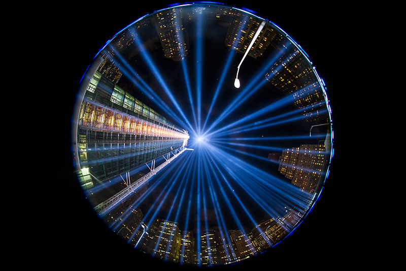In a photo taken with a fish eye lens, the two beams of light meet in the art installation "The Tribute in Light" projecting in the night sky over Manhattan on Sept. 11, 2015. (Gordon Donovan)