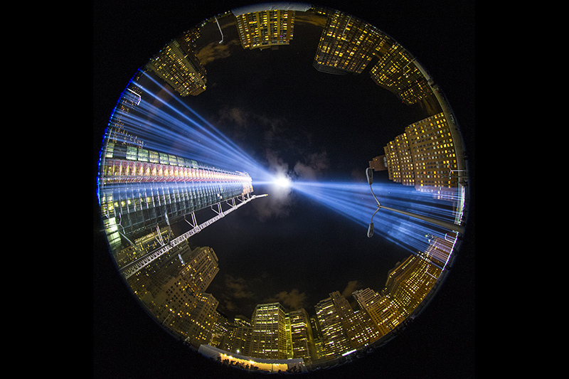 In a photo taken with a fish eye lens, the two beams of light meet in the art installation "The Tribute in Light" projecting in the night sky over Manhattan on Sept. 11, 2015. (Gordon Donovan/Yahoo News)