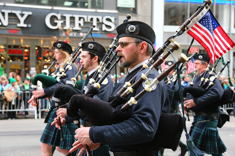 A member of the Westchester Plumbers and Steamfitters local play the bagpipes while marching Fifth Ave. during the St. Patrick's Day Parade, March 17, 2015, in New York. (Gordon Donovan)