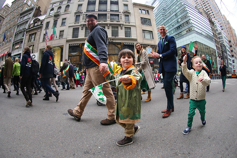 Children wave to the crowds while marching up Fifth Ave. during the St. Patrick's Day Parade, March 17, 2015, in New York. (Gordon Donovan)