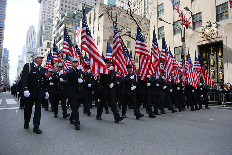 Members of FDNY Emerald Society carrying flags make their way onto Fifth Ave. during the St. Patrick's Day Parade, March 17, 2015, in New York. (Gordon Donovan)