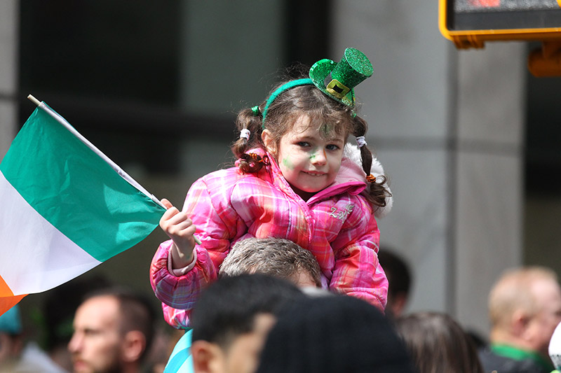 Youngsters dressed in green watch the St. Patrick's Day Parade, March 17, 2015, in New York. (Gordon Donovan)