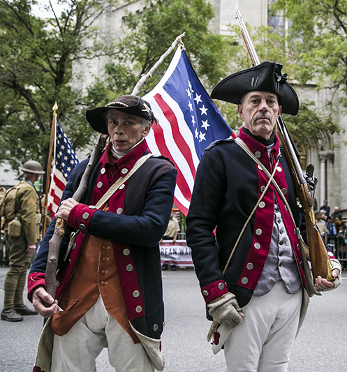 People dressed as soldiers from the American Revolutionary War pose for a photo during the Veterans Day parade on Fifth Avenue in New York on Fifth Avenue in New York on Nov. 11, 2015. (Gordon Donovan)