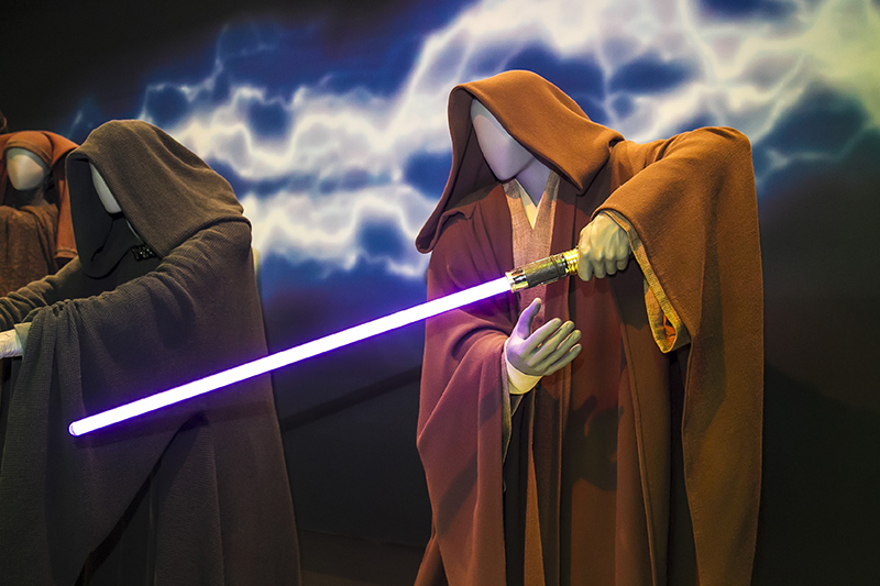 The costume of the Jedi had an immediate effect on the actors who wore them, and influenced their portrayals. The success of the lightsaber, the signature weapon of the Jedi and Sith, is achieved through the combination of cutting-edge sound and visual effects, the actor's extensive sword training and careful choreography. (Gordon Donovan/Yahoo News)