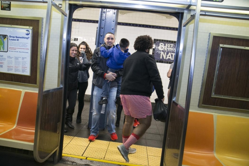 Passengers get a laugh as they board the subway as people take part in the No Pants Subway Ride in New York City, Sunday, Jan. 10, 2016. The No Pants Subway Ride began in 2002 in New York as a stunt and has taken place in cities around the world since then. (Gordon Donovan/Yahoo News)