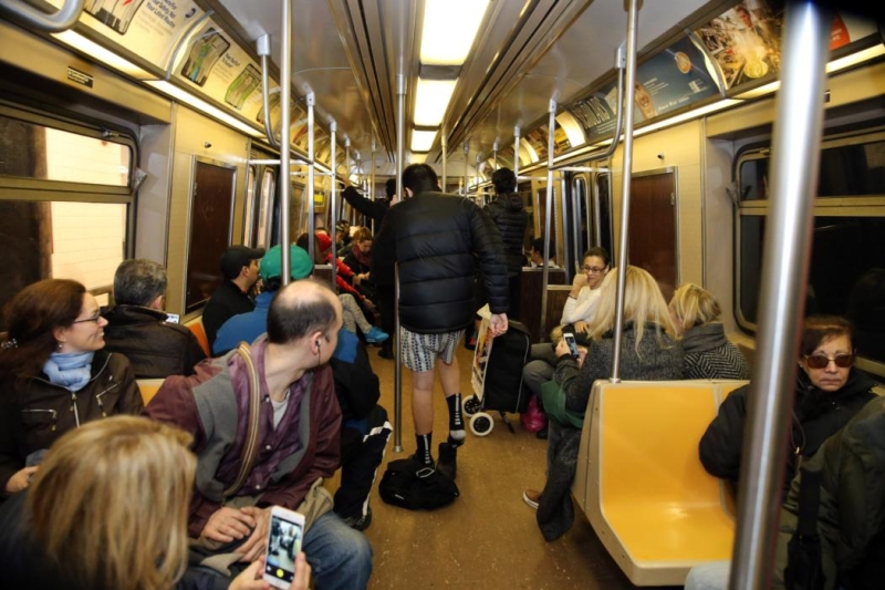 Passengers watch in amusement on the subway as people remove their pants as they take part in the No Pants Subway Ride in New York City, Sunday, Jan. 10, 2016. The No Pants Subway Ride began in 2002 in New York as a stunt and has taken place in cities around the world since then. (Gordon Donovan/Yahoo News)