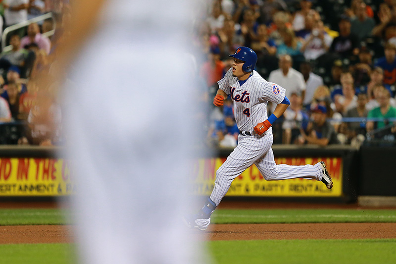 New York Mets Wilmer Flores (4) doubles in the fourth inning of a baseball game against the Colorado Rockies at Citi Field in New York, Tuesday, Aug. 11, 2015. (Gordon Donovan)