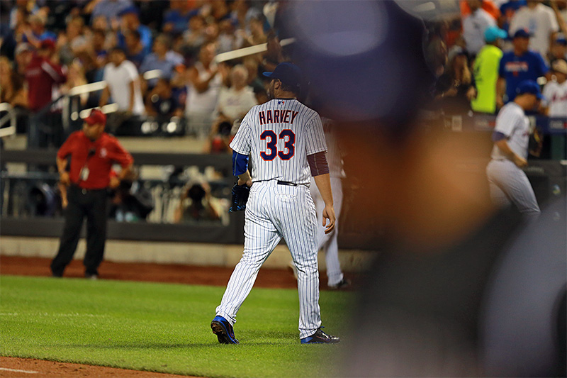 New York Mets starting pitcher Matt Harvey (33) comes off the field in the sixth inning of a baseball game against the Colorado Rockies at Citi Field in New York, Tuesday, Aug. 11, 2015. (Gordon Donovan)