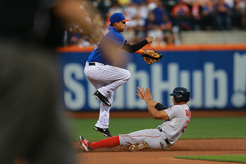New York Mets Ruben Tejada (11) goes airborne over Boston Red Sox Xander Bogaerts (2) for the double play in the third inning of a baseball game against the Boston Red Sox at Citi Field in New York, Friday, Aug. 28, 2015. (Gordon Donovan)