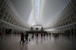 People walk through the Oculus mall at World Trade Center on Monday, August 22, 2016. It stretches along a four-block underground network that spans the bases of three office towers. While mostly below street level, light beams in through the windows of the winged Oculus, designed by Santiago Calatrava, that top the transportation hub of 13 subway trains and river ferries. (Gordon Donovan/Yahoo News)