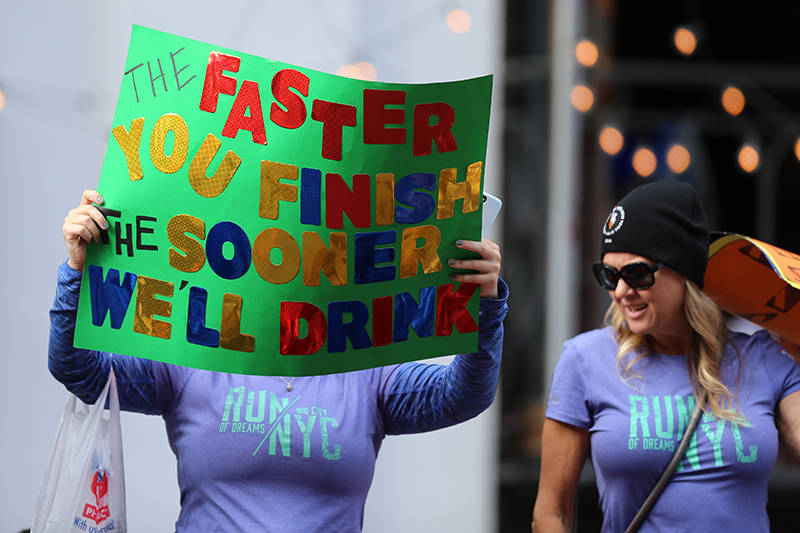 A supporter holds up a sign of guidance and strategy on First Ave. during the 2016 New York City Marathon, Nov. 6, 2016. (Gordon Donovan/Yahoo News)