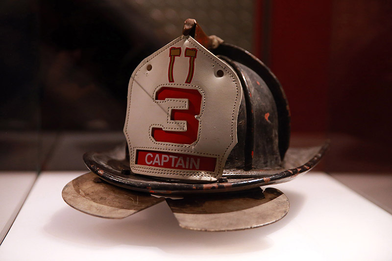The description that reads along side Pat Brown's helmet in the 9/11 Memorial and Museum, "Responding on 9/11, Ladder Company 3, Captain Patrick "Paddy" Brown wore a different helmet than one he had left in the trunk of his car. It was this unworn helmet, recently relined, that served as Brown's surrogate at a memorial service held in St. Patrick's Cathedral on November 9, 2001, the date that would have been his 49th birthday." (Photo: Gordon Donovan/Yahoo News)
