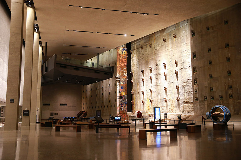 Foundation Hall is a room of massive scale, with ceilings ranging from 40 to 60 feet and nearly 15,000 square feet of floor space. Visitors see a portion of the slurry wall, a surviving retaining wall of the original World Trade Center that withstood the devastation of 9/11. Against this backdrop, the Last Column stands 36-feet high and is covered with mementos, memorial inscriptions, and missing posters placed there by ironworkers, rescue workers and others. (Photo: Gordon Donovan/Yahoo News)