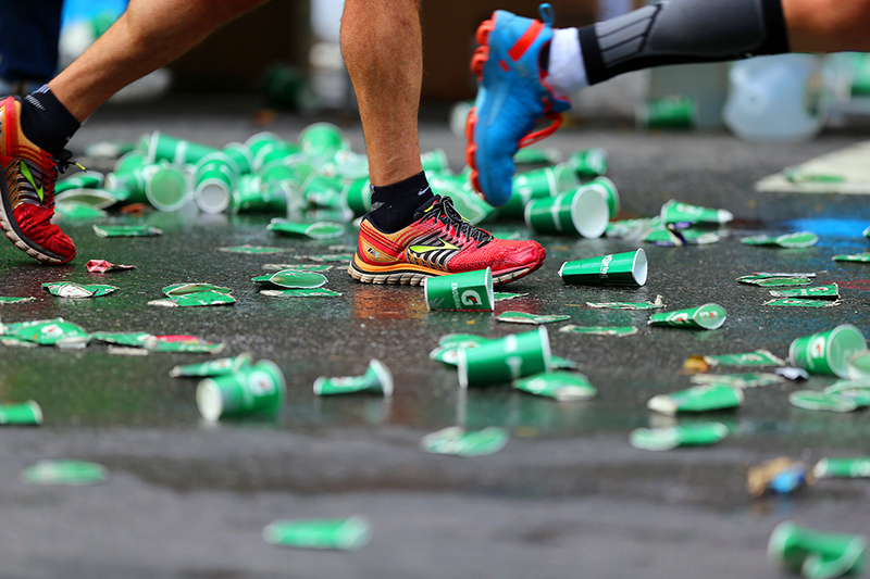 Runners step on used water cups discarded on the street during the 2016 New York City Marathon, Nov. 6, 2016. (Gordon Donovan/Yahoo News)