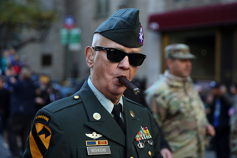 A veteran enjoys a good cigar as he marches up Fifth Avenue during the Veterans Day parade in New York City on Nov. 11, 2016. (Gordon Donovan/Yahoo News)