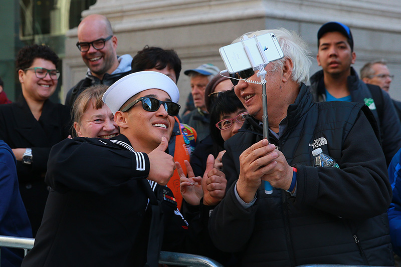 A member of the Navy takes a selfie with a spectator during the Veterans Day parade in New York on Nov. 11, 2016. (Gordon Donovan/Yahoo News)