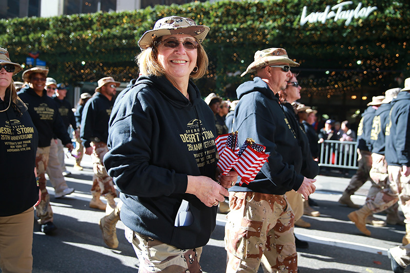 A Desert Storm veteran carries flags in the Veterans Day parade in New York City on Nov. 11, 2016. (Gordon Donovan/Yahoo News)
