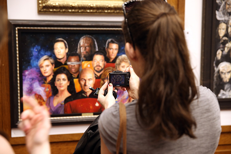 Visitors take photos of the original art from the exhibit “Star Trek: 50 Artists. 50 Years.” (Photo: Gordon Donovan/Yahoo News)
