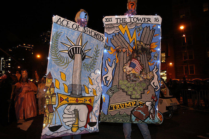 A couple visiting from Seattle participate with his and hers walking campaign cards for 2016 elections during the 43rd annual Village Halloween Parade in New York City on Oct. 31, 2016. (Gordon Donovan/Yahoo News)