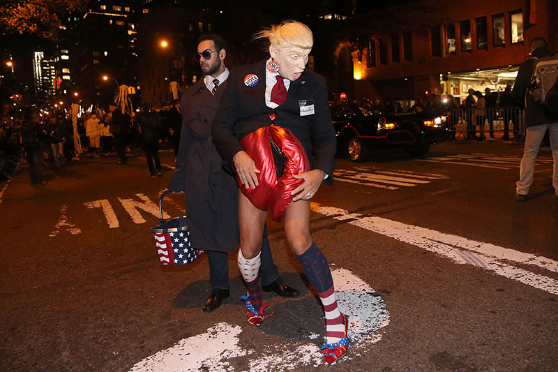 A young man wears a Donald Trump mask with a friend dressed as a Secret Service agent during the 43rd annual Village Halloween Parade in New York City on Oct. 31, 2016. (Gordon Donovan/Yahoo News)