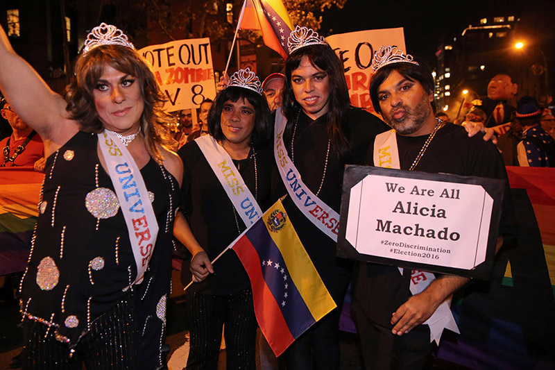 Four supporters of Alicia Machado wave Venezuela flags during the 43rd annual Village Halloween Parade in New York City on Monday, Oct. 31, 2016. (Gordon Donovan/Yahoo News)