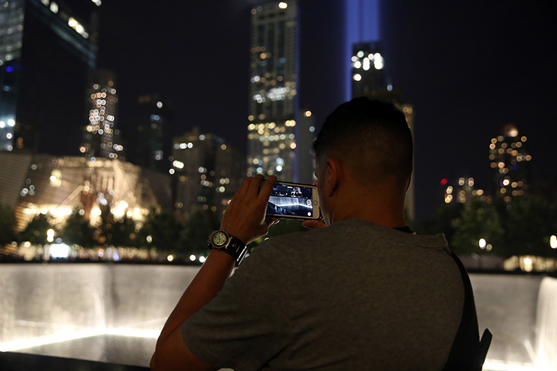 A visitor takes a photo of the Tribute in Light at the National September 11 Memorial & Museum on Sept. 10, 2016. (Gordon Donovan/Yahoo News)