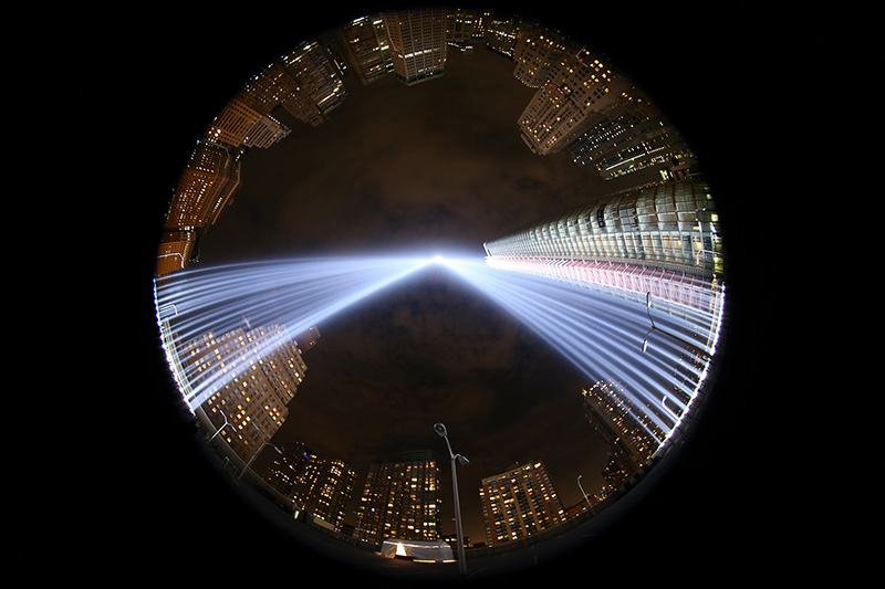 In a photo taken with a fisheye lens, the two beams of light meet in the art installation "The Tribute in Light" projecting in the night sky over Manhattan on Sept. 10, 2016. (Gordon Donovan)