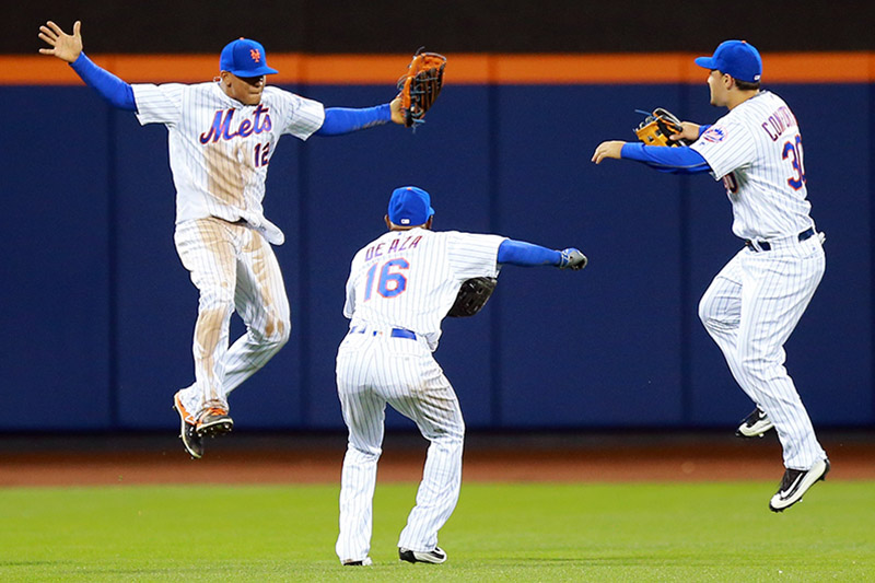 New York Mets outfielders Juan Lagares (12), Alejandro De Aza (16) and Michael Conforto (30) celebrate the Mets 5-2 win against the Cincinnati Reds at Citi Field in New York, Wednesday, April 27, 2016. (Gordon Donovan)