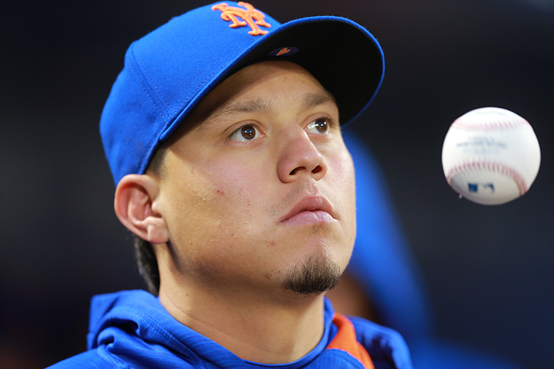 New York Mets Wilmer Flores stays loose in the dugout during a baseball game against the San Francisco Giants at Citi Field in New York, Friday, April 29, 2016. (Gordon Donovan)