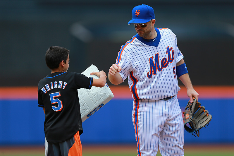 New York Mets 3B David Wright (5) fist bumps a young fan in the seventh inning of a baseball game against the Milwaukee Brewers at Citi Field in New York, Sunday, May 22, 2016. (Gordon Donovan)