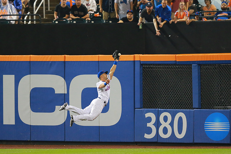 New York Mets Justin Ruggiano (1) leaps but can't make the catch in the fourth inning of a baseball game against the Colorado Rockies at Citi Field in New York, Saturday, July 30, 2016. (Gordon Donovan)