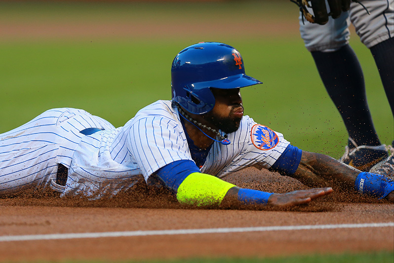 New York Mets Jose Reyes (7) slides head first into 3B in the first inning of a baseball game against the San Diego Padres at Citi Field in New York, Saturday, Aug. 13, 2016. (Gordon Donovan)