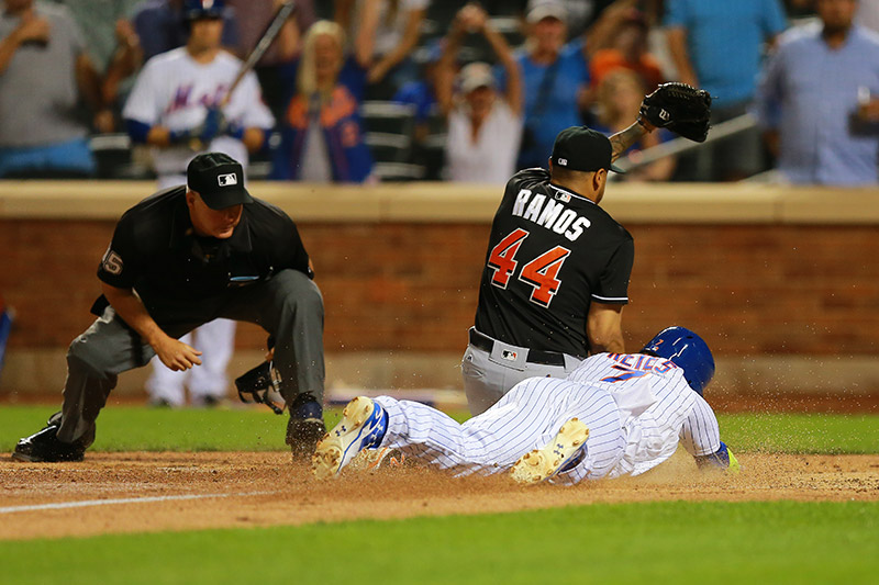 New York Mets Jose Reyes (7) scores as he collides with Miami Marlins relief pitcher A.J. Ramos (44) on a wild pitch in the eighth inning of a baseball game at Citi Field in New York, Monday, August 29, 2016. (Gordon Donovan)