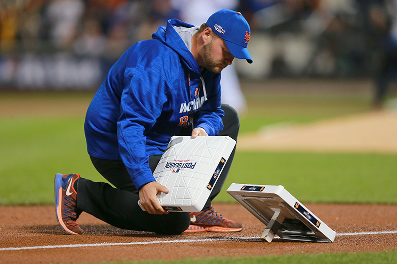 New York Mets grounds crew manager Ryan Woodley changes bases in between innings during the National League wild-card baseball game against the San Francisco Giants at Citi Field in New York, Wednesday, October 5, 2016. The Giants beat the Mets 3-0 to advance to the NLDS. (Gordon Donovan)