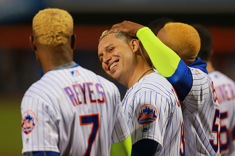 New York Mets Asdrubal Cabrera (13) gets a hand rub from Yoenis Cespedes (52) during player introductions before the National League wild-card baseball game against the San Francisco Giants at Citi Field in New York, Wednesday, October 5, 2016. (Gordon Donovan)