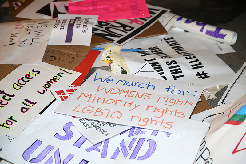 Discarded signs from Women's March sit in pile near a construction in New York City on Jan. 21, 2017. (Gordon Donovan/Yahoo News)