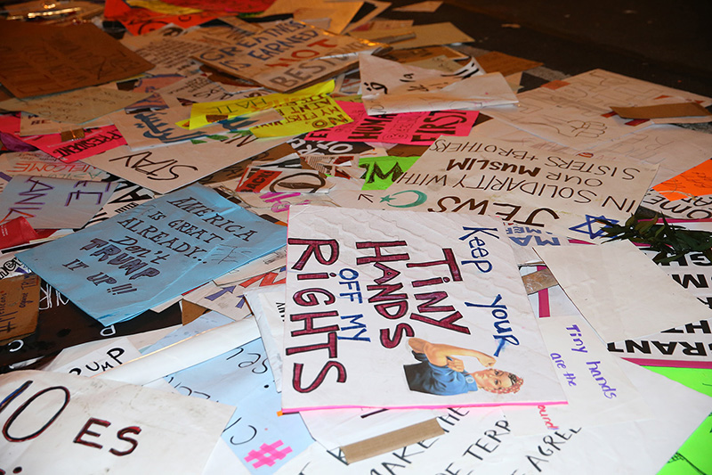 Discarded signs from Women's March lie on streets around the corner from Trump Tower in New York City on Jan. 21, 2017. (Gordon Donovan/Yahoo News)