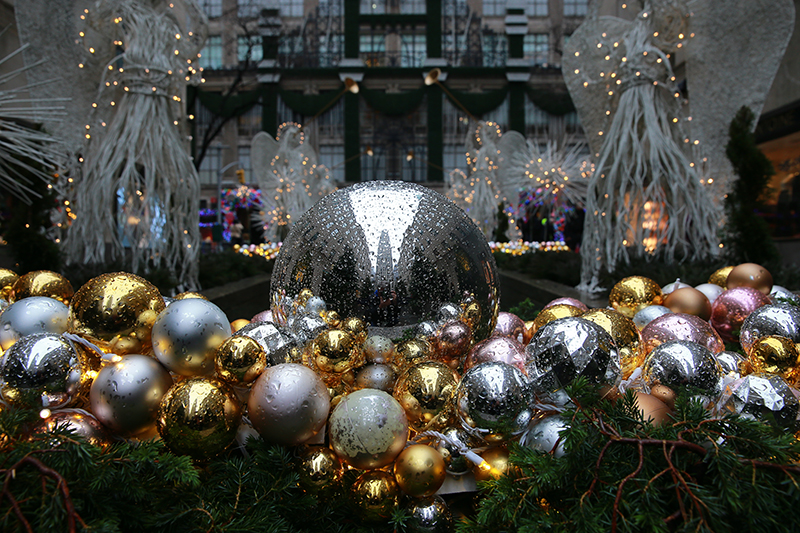Raindrops cover the ornaments in the Garden with a relection of Rockefeller Center. (Gordon Donovan/Yahoo News)