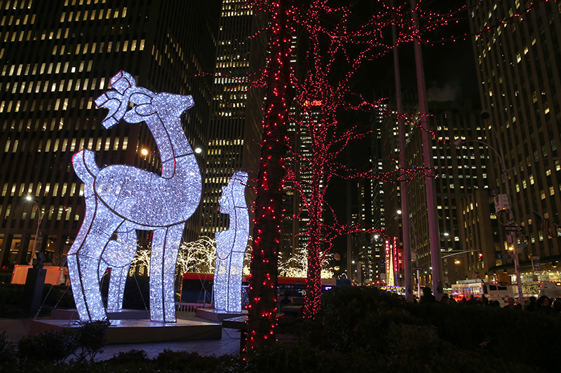 Reindeer made of lights stand tall on a podium outside an office building on Sixth Avenue in New York City. (Gordon Donovan/Yahoo News)