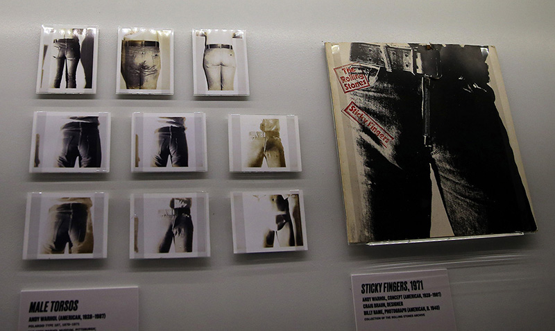 The Rolling Stones "Sticky Fingers" album cover from 1971 and photographs of male torsos. The concept came from Andy Warhol and was designed by Craig Braun. The Polaroid pictures were taken by photographer Billy Name. The album features the first usage of the "tongue & lips" logo of Rolling Stones Records. (Gordon Donovan/Yahoo News)
