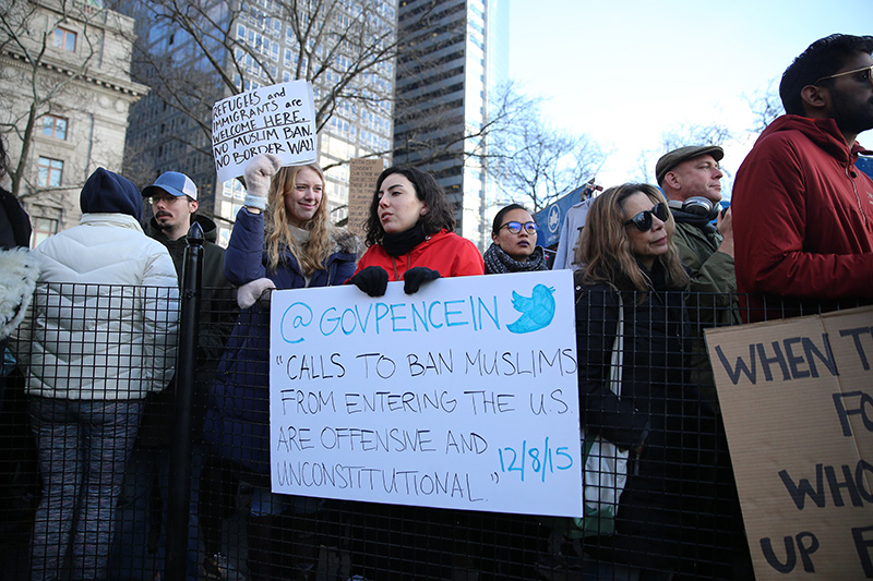 People hold up signs as they gather for a rally in New York's Battery Park in New York, Jan. 29, 2017, protesting President Donald Trump's immigration order. (Gordon Donovan/Yahoo News)